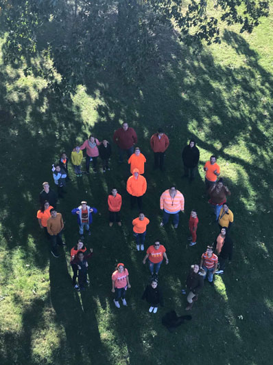 An overhead photo shows a group of special education teachers gathered outside their school.
