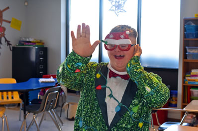 A student from an autism support program smiles in a holiday costume 