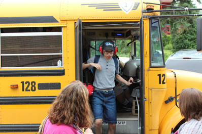A special education student steps off his bus.
