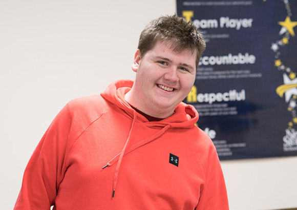 High school student at special education school smiling.