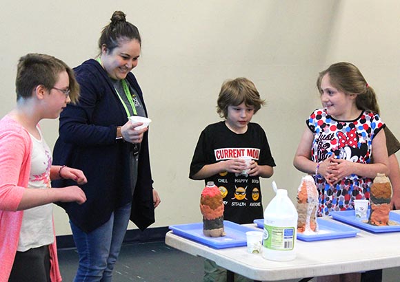 Special education students and a teacher perform science experiments as part of their STEAM education.