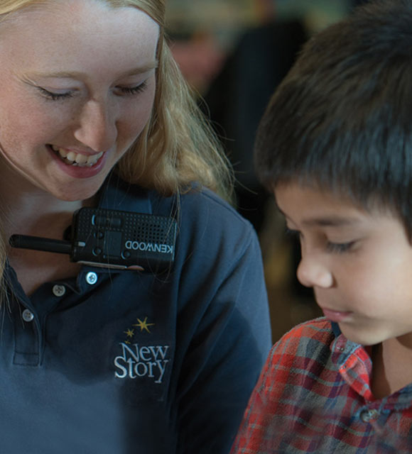 Special education teacher using applied behavior analysis to help elementary school boy learn.