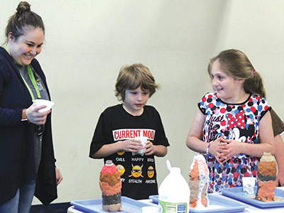 Special education students and a teacher perform science experiments as part of their STEAM education.