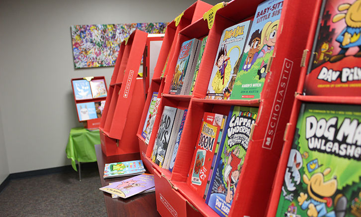 books displayed in classic red scholastic book fair shelves.