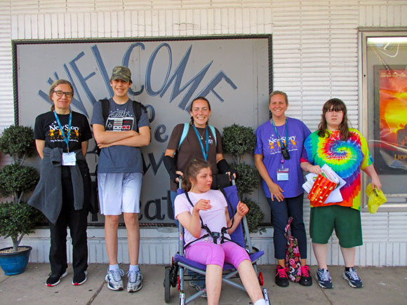 Special education students, teachers, and staff smile on a field trip to the movies