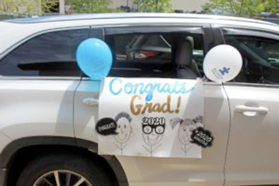 car with congratulations sign