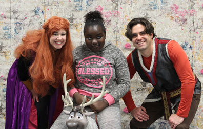 A high school girl smiles with movie characters.