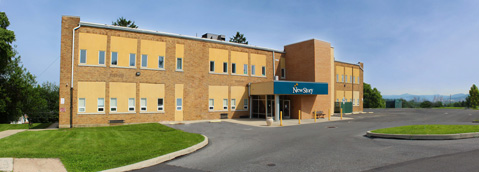 A tan building with a blue awning serves as a special education school.