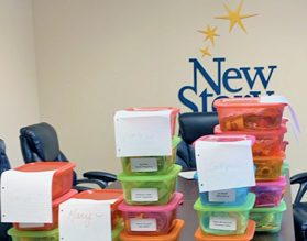 Brightly colored plastic boxes stacked and labeled