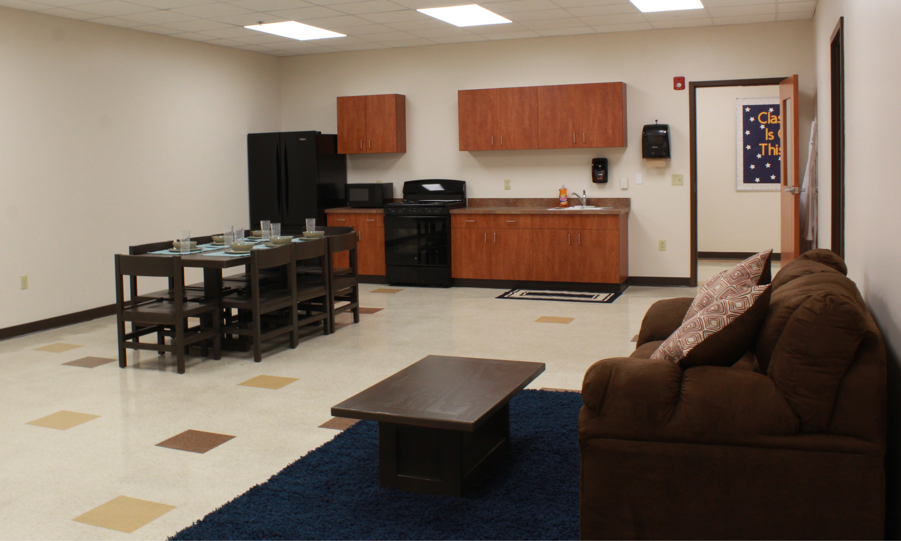 New Story Schools in Carlisle Life Skills Room, a basic kitchenette, table and couch. 