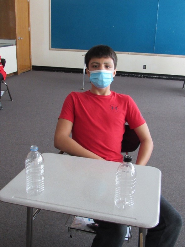 Students learn about tornadoes in class and make their own using soda bottles.