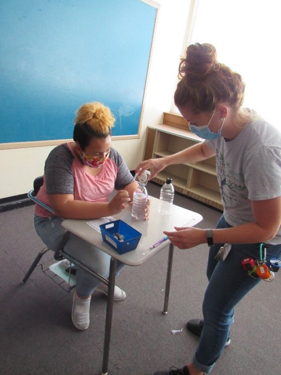 Students learn about tornadoes in class and make their own using soda bottles.