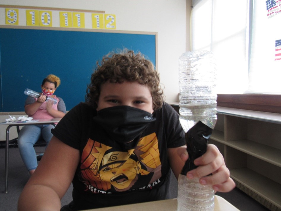 Students learn about tornadoes in class and make their own using soda bottles.