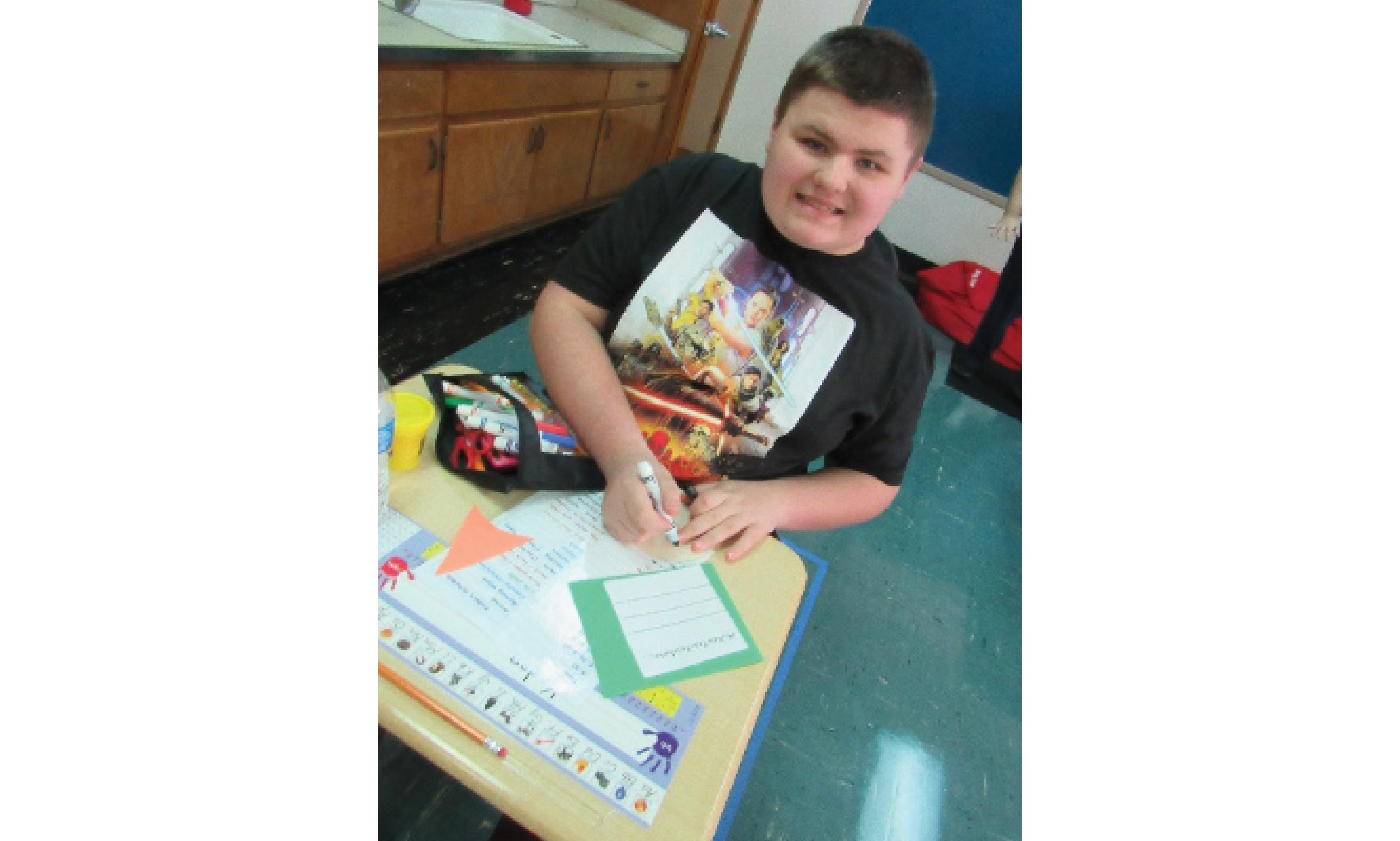 Student at Desk with New Year's Resolution Crafts.