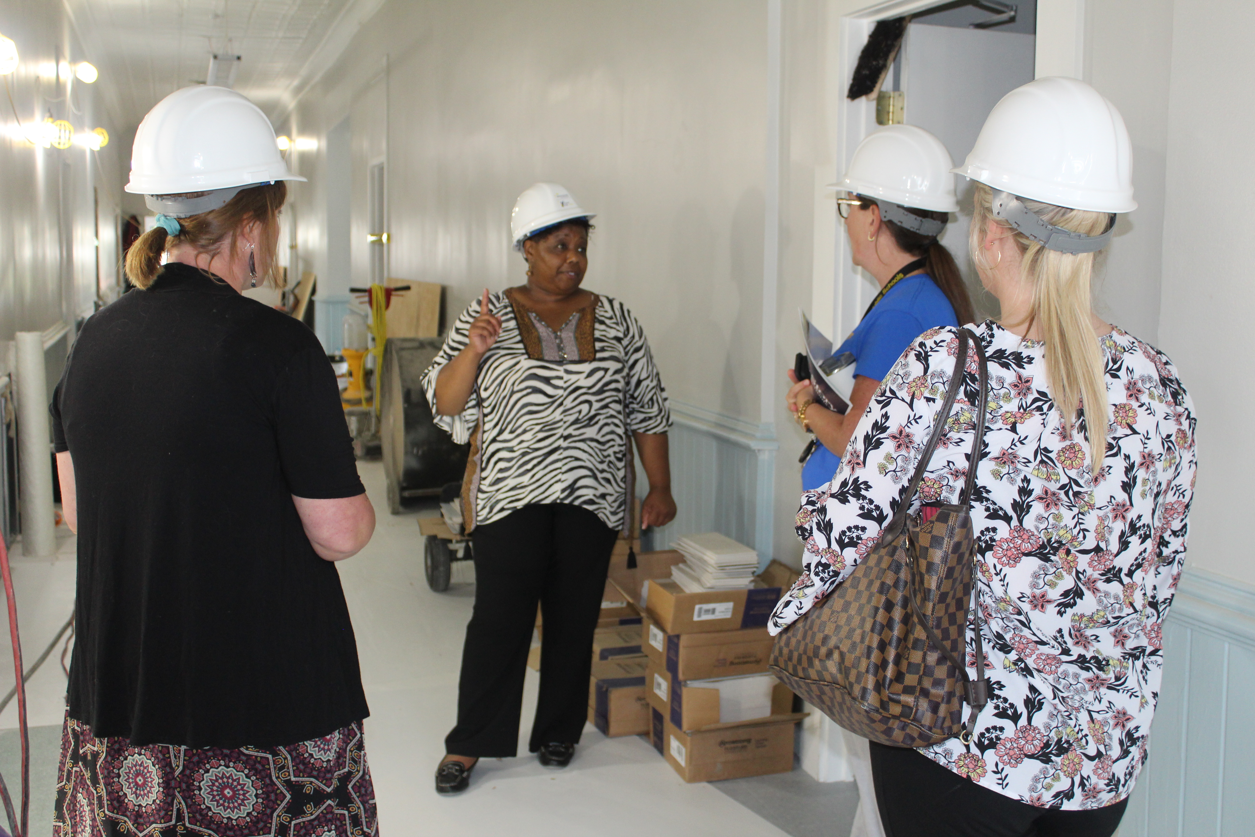 4 women talking in building