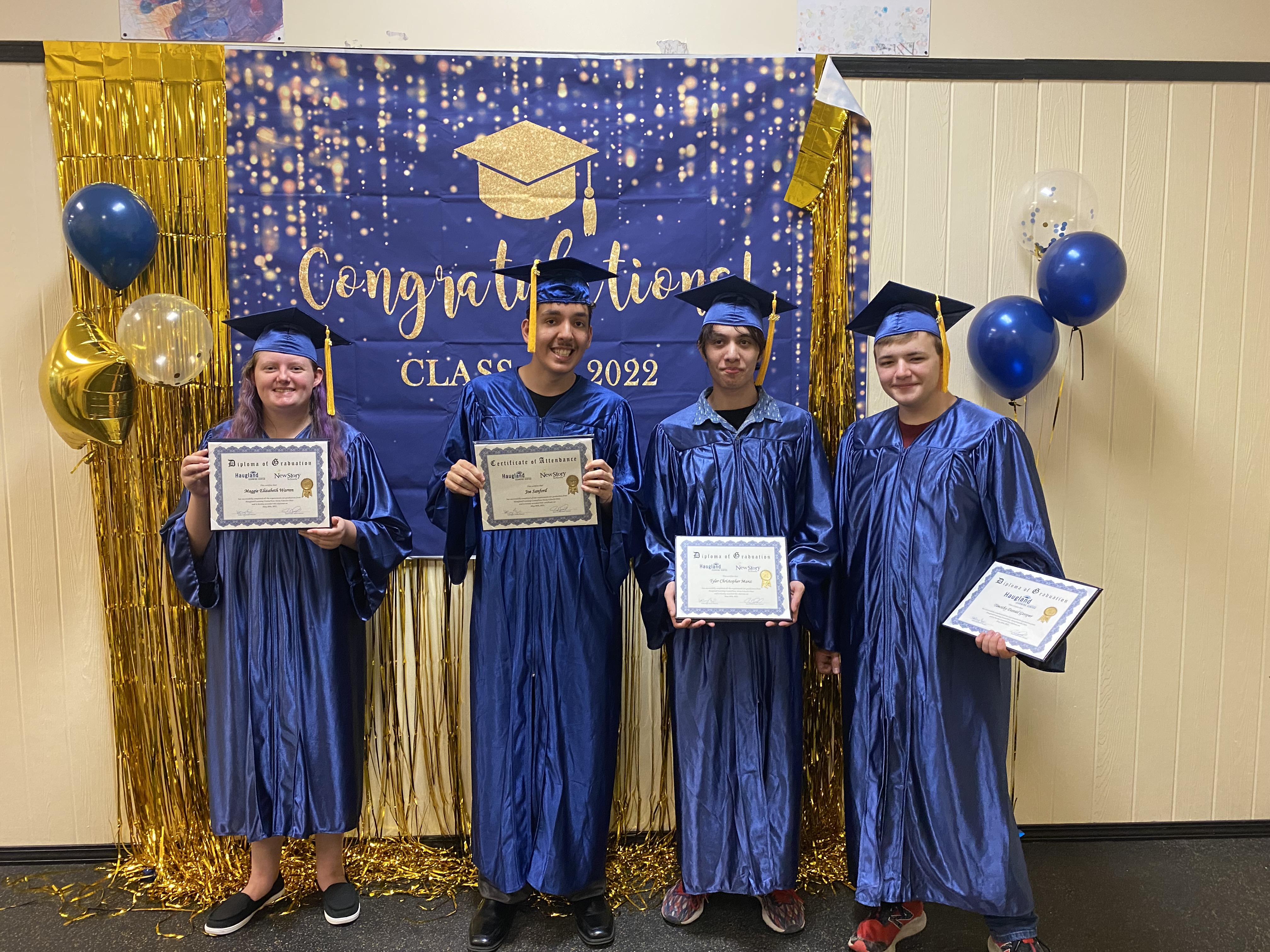 Graduates holding diplomas and certificates