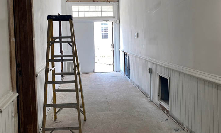 Hallway with door and ladder on left side