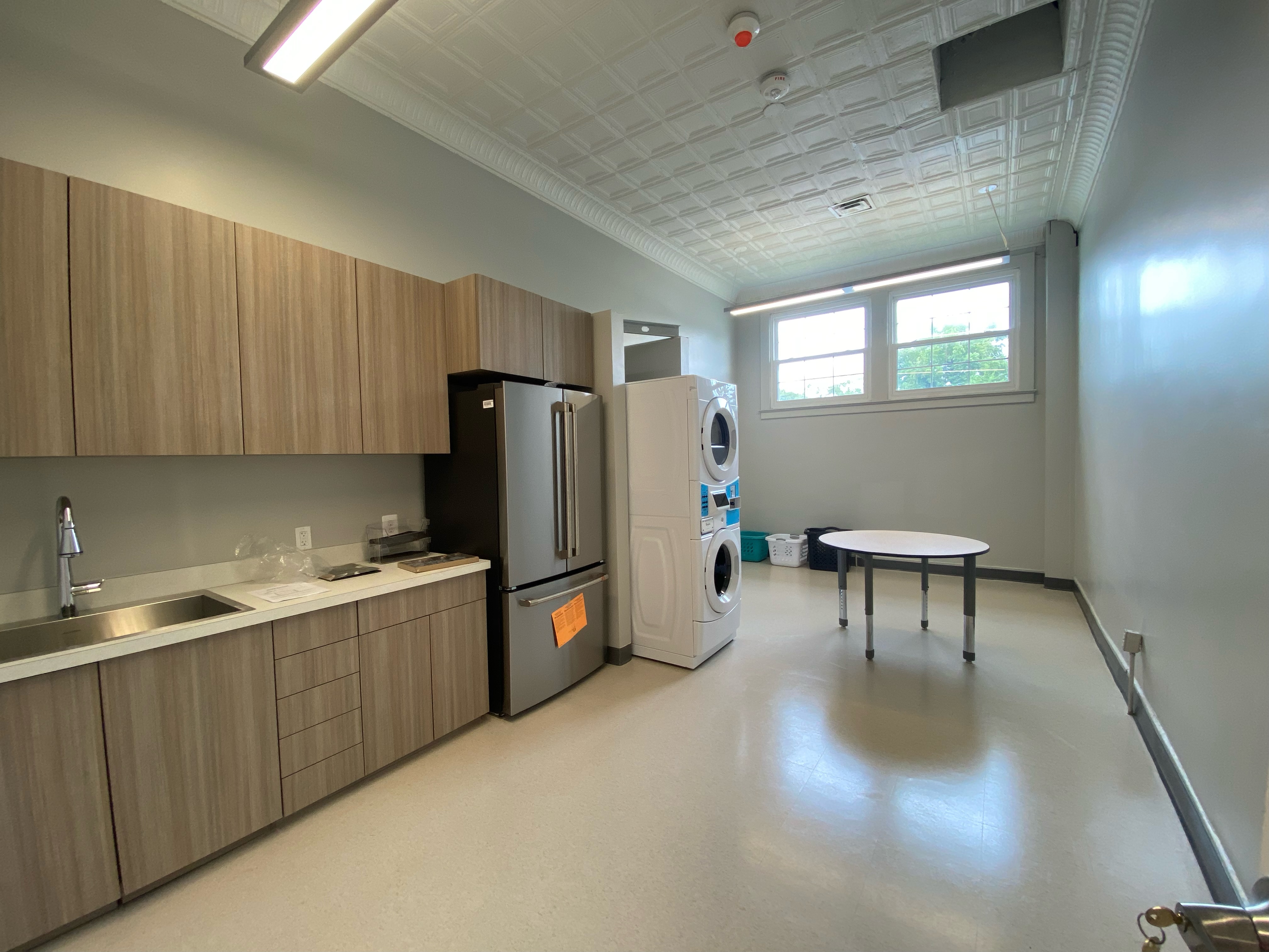 Lifeskills room with fridge, counters, washer, and dryer