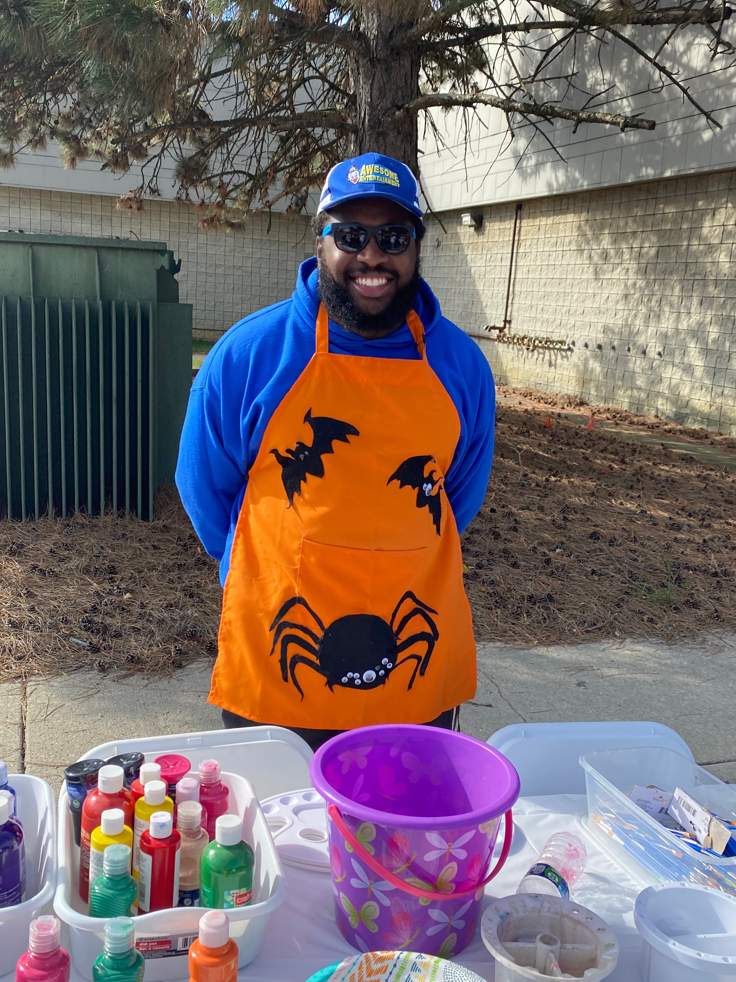 Staff working the pumpkin painting table